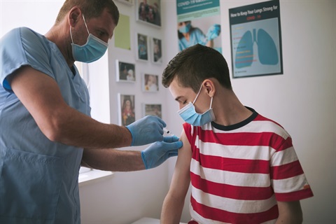 Teen boy gets COVID vaccine at doctor's office