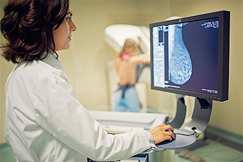 Doctor looks at mammogram image on computer screen