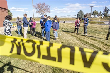 Children Out on a Field with Caution Tape