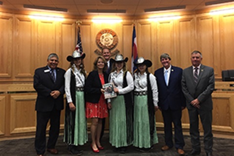 Fair royalty presents fair book to commissioners